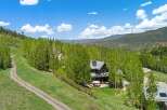 Nestled amidst lush greenery and mature trees, this stunning mountain home offers breathtaking panoramic views.