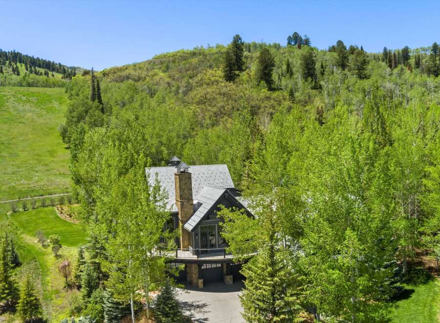 Nestled amidst lush greenery and mature trees, this stunning mountain home offers a serene escape.