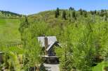 Nestled amidst lush greenery and mature trees, this stunning mountain home offers a serene escape.