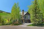 Experience luxury mountain living in this stunning home, nestled against a backdrop of rolling green hills and mature trees.