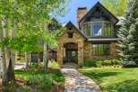 Discover this stunning mountain home featuring a grand stone entryway and a charming covered porch.