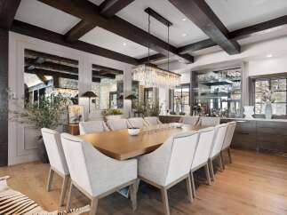 Experience elegant dining in this sophisticated space, featuring a grand wooden dining table surrounded by plush upholstered chairs.