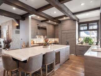 Experience luxury mountain living in this stunning kitchen, featuring a spacious marble island perfect for entertaining and a sleek, modern design.