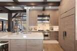 Experience luxury mountain living in this stunning kitchen featuring custom wood cabinetry and a sleek Wolf range.