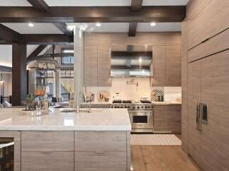 Experience luxury mountain living in this stunning kitchen featuring custom wood cabinetry and a sleek Wolf range.