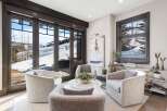Experience luxurious mountain living in this stunning living area, featuring plush, modern seating arranged around a chic marble coffee table.