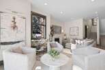 Experience luxury living in this stunning modern living room, featuring a cozy fireplace and elegant artwork.
