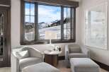 Enjoy breathtaking mountain views from this cozy seating area, perfect for relaxing after a day on the slopes.