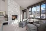 Experience luxury living with this stunning living room featuring a grand marble fireplace, perfect for cozy evenings.