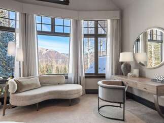 Experience luxury living with breathtaking mountain views from this elegant bedroom.
