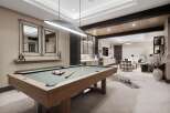 Experience ultimate relaxation and entertainment in this luxurious game room, featuring a professional billiard table and a stylish lounge area.