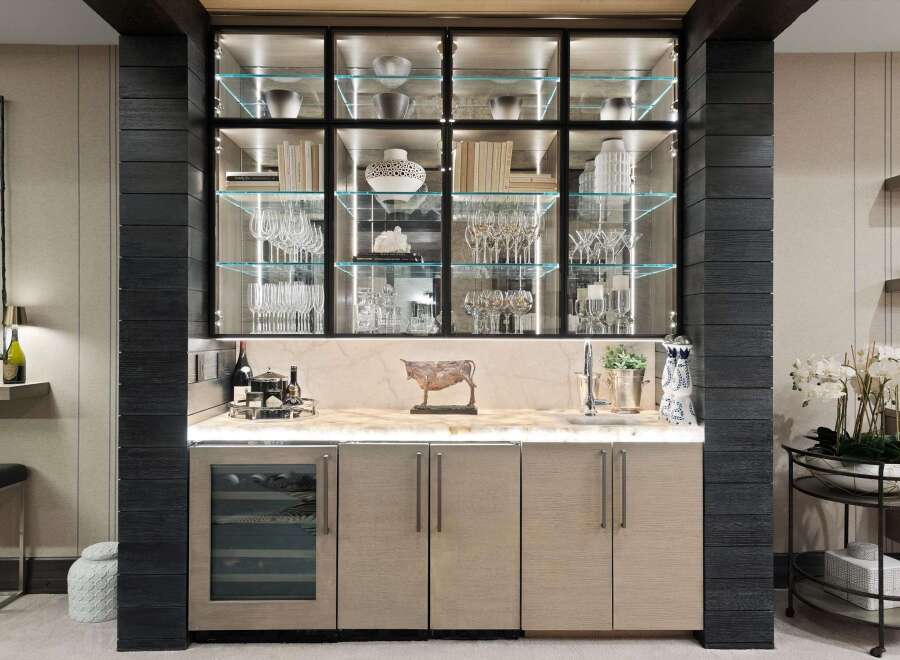 Elevate your entertaining with this sophisticated bar area, featuring a sleek glass-front wine cooler and ample cabinet storage.