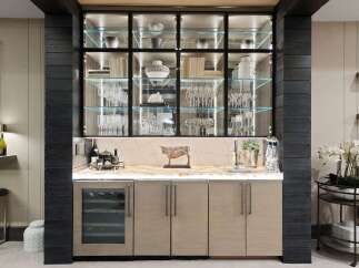 Elevate your entertaining with this sophisticated bar area, featuring a sleek glass-front wine cooler and ample cabinet storage.