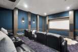 Experience cinematic luxury in this state-of-the-art home theater, featuring plush reclining leather seats with built-in cup holders for ultimate comfort.
