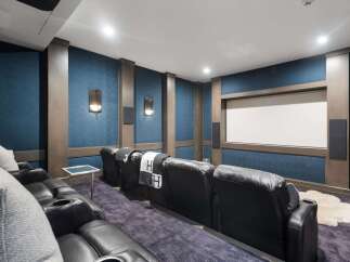 Experience cinematic luxury in this state-of-the-art home theater, featuring plush reclining leather seats with built-in cup holders for ultimate comfort.