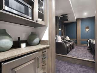 Experience cinematic bliss in this home theater, featuring plush leather recliners and a projector for an immersive viewing experience.