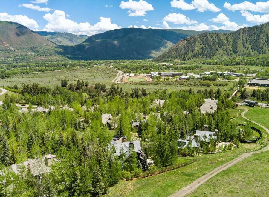 Nestled amidst lush greenery and majestic mountains, this property offers a serene escape with its stunning architecture and expansive grounds.