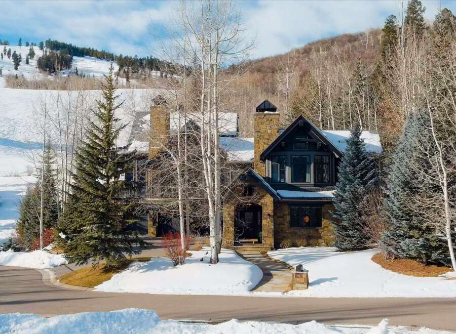Experience luxury mountain living in this stunning stone-clad home, perfectly situated with breathtaking ski slope views.