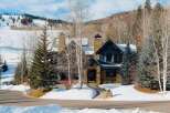 Experience luxury mountain living in this stunning stone-clad home, perfectly situated with breathtaking ski slope views.