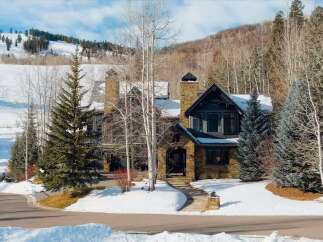 Experience luxury mountain living in this stunning stone-clad home, perfectly situated with breathtaking ski slope views.