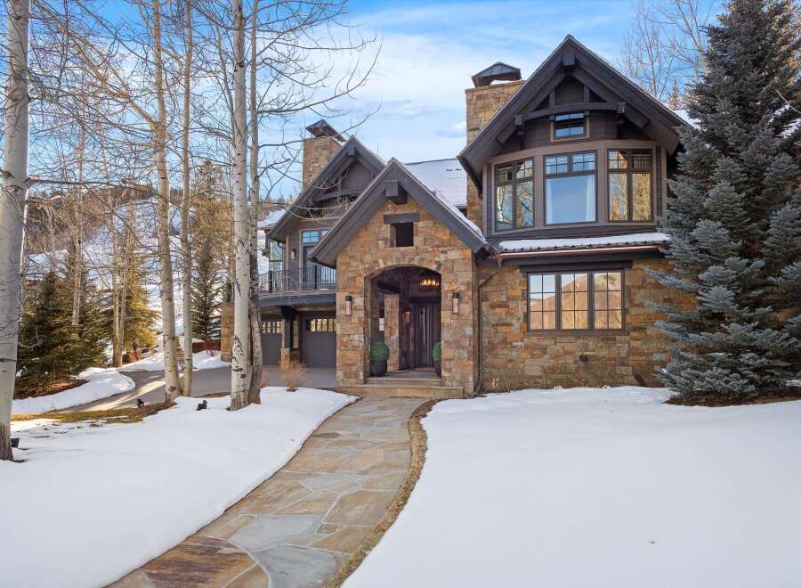 Experience luxury mountain living in this stunning stone and timber home, nestled amidst a winter wonderland.