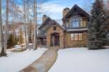 Experience luxury mountain living in this stunning stone and timber home, nestled amidst a winter wonderland.