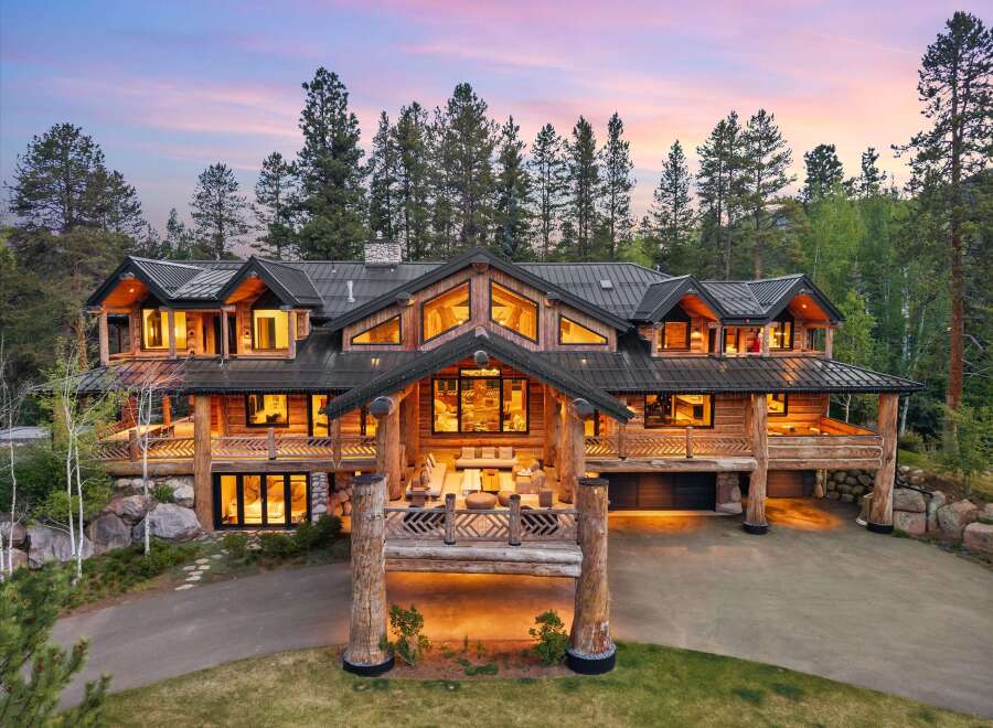 Experience luxury mountain living in this stunning log home, nestled amidst towering pine trees.