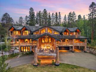 Experience luxury mountain living in this stunning log home, nestled amidst towering pine trees.