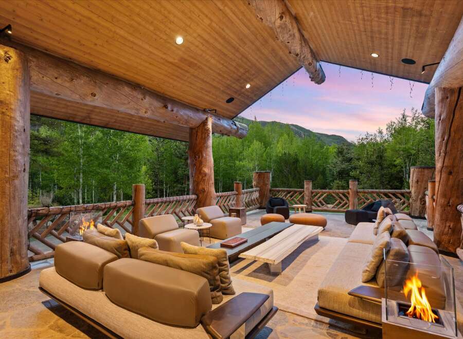 Experience luxurious outdoor living with this stunning covered patio, featuring a spacious seating area perfect for entertaining.