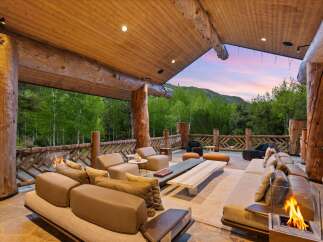 Experience luxurious outdoor living with this stunning covered patio, featuring a spacious seating area perfect for entertaining.