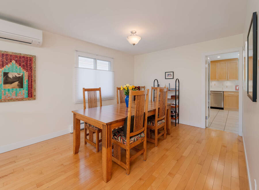This dining room features a beautiful wooden dining table with six chairs, perfect for family gatherings.