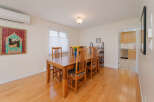 This dining room features a beautiful wooden dining table with six chairs, perfect for family gatherings.