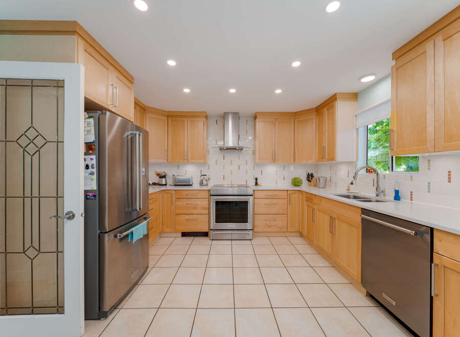 Step into this beautifully updated kitchen featuring sleek stainless steel appliances, including a refrigerator, range, and dishwasher.