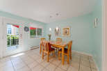 Bright and airy dining area featuring a light wood table with four chairs, perfect for intimate meals.