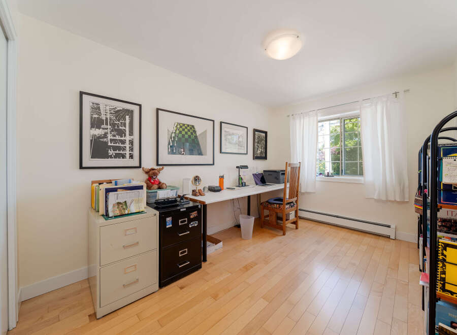 This home office features a spacious desk with a laptop and printer, perfect for productivity.