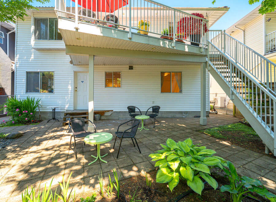 Enjoy outdoor living in this charming backyard featuring a paved patio area perfect for entertaining.