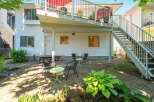Enjoy outdoor living in this charming backyard featuring a paved patio area perfect for entertaining.
