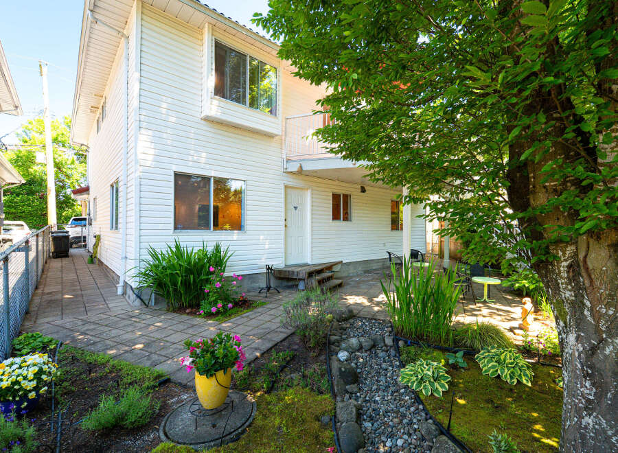 Discover this charming property featuring a well-maintained exterior with white siding and a welcoming entryway.