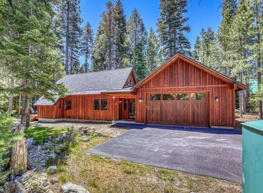 Nestled amongst tall pine trees, this charming wooden home offers a serene mountain retreat.