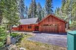 Nestled amongst tall pine trees, this charming wooden home offers a serene mountain retreat.
