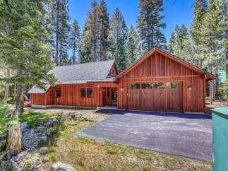 Nestled amongst tall pine trees, this charming wooden home offers a serene mountain retreat.