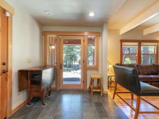 Step into this inviting entryway featuring a convenient drop-leaf table perfect for quick meals or extra workspace.