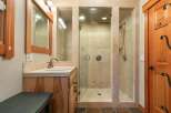 Experience luxury in this spacious bathroom featuring a walk-in shower with dual shower heads and elegant tilework.