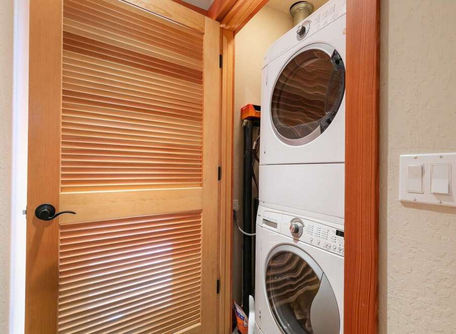 Discover the convenience of a stacked washer and dryer unit, perfect for maximizing space in this home.