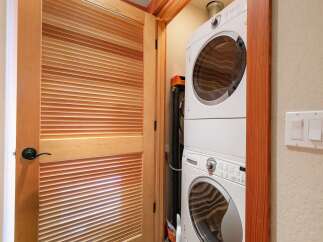 Discover the convenience of a stacked washer and dryer unit, perfect for maximizing space in this home.