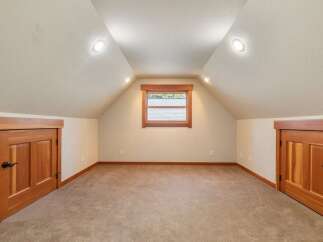 Discover this charming attic space, perfect for a home office or extra storage.