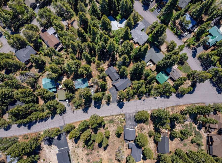 Discover this charming mountain retreat nestled amongst towering trees, offering a serene and private escape.