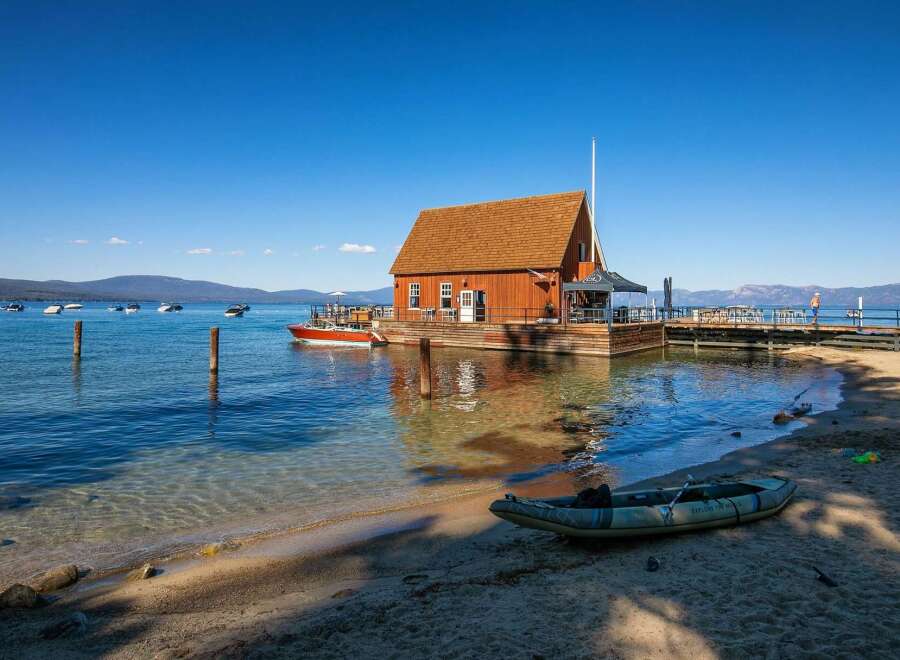 Experience waterfront living at its finest with this unique property featuring a charming wooden boathouse on a floating dock.