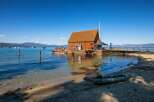 Experience waterfront living at its finest with this unique property featuring a charming wooden boathouse on a floating dock.
