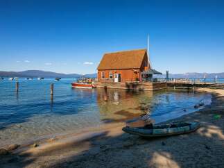Experience waterfront living at its finest with this unique property featuring a charming wooden boathouse on a floating dock.